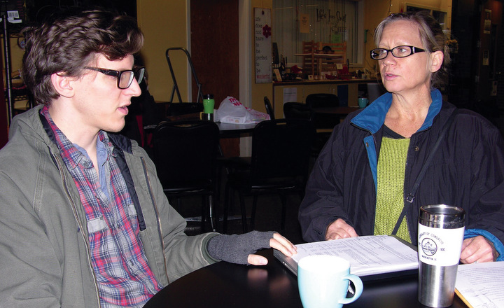 Bethel College senior Will Shoup, left, and Ami Regier, professor of literary studies, talk over their first real workshop experience held with a group of inmates at Hutchinson Correctional Facility, part of an arts in prison project Regier and Shoup are carrying out. — Melanie Zuercher/Bethel College