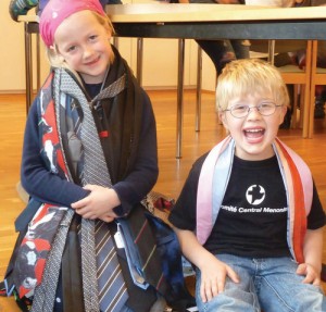 Children enjoy the neckties from Krefeld, Germany, before the ties made the journey to Pennsylvania to be turned into bags for the Mennonite World Conference assembly. — Gerda Landes