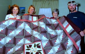 Siblings Lois Wollman of Freeman, S.D., Karen Franklin of Wichita, Kan., and David Epp of Hillsboro surprise their mother, Rosella Epp of Hillsboro, second from right, with a beloved quilt. — Karen Franklin