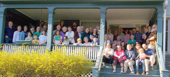 Members of Reba Place Fellowship gathered in April at 727 Reba Place in Evanston, Ill., where the fellowship first began in 1957. — Reba Place Fellowship