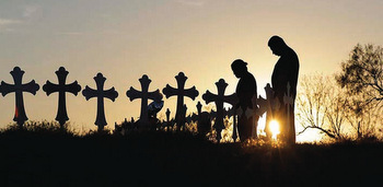 Mourners visit a makeshift memorial with crosses placed near the scene of the mass shooting at First Baptist Church of Sutherland Springs, Texas. — Eric Gay/Associated Press