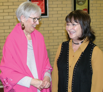 Florence Schloneger, left, wears a shawl presented by Pauline Sharp, right, a member of the Kanza Heritage Society board, in appreciation of Schloneger’s gift to establish the organization. — Tim Huber/MWR