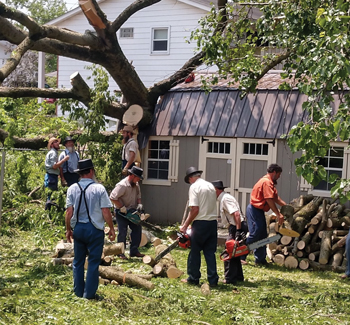 Mennonite Disaster Service volunteers clean up damage from an EF-1 tornado that hit Pendleton, Ind., May 27. About 75 homes were damaged by the storm, which sustained winds of about 100 mph and advanced into Ohio, where it and other storms caused 5 million people to lose power. — Darin Bontrager/MDS