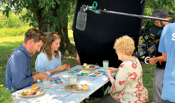 Cinematographer Derek Fisher, right, films while Derek Hamm, Katherine Goering Hamm and Aleen Ratzlaff play Dutch Blitz during a potluck scene. — Chris Knitter