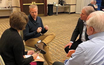Mennonite Church USA Executive Board members discussed the Membership Guidelines Advisory Group report in small groups during their meeting Jan. 17-18 in Kansas City, Mo. From left are Michelle Dula, Jon Carlson and Jim Caskey, Executive Board members; and Duane Oswald, an expert in Mennonite church leadership. — Camille Dager/MC USA