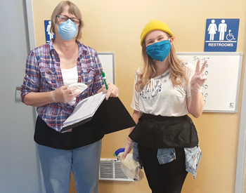 Staff members Barbara Moe and Grace Helmcke sign up people for showers at God’s Little Acre, Seattle Mennonite Church’s drop-in center. — Jonathan Neufeld/Seattle Mennonite Church