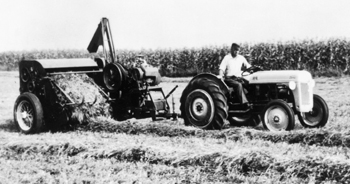 Ed Nolt testing the automatic self-tying baler with a Ford 8N tractor. — New Holland North America