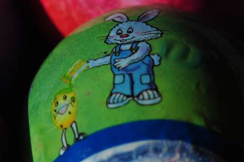 Bunny pouring paint on eggs head