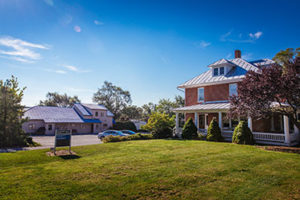 The Weaver house (foreground) with the current incarnation of Martin Store to the left. Both buildings currently house programs in the Center for Justice and Peacebuilding. In the 1930s, the Weaver family opened a small store serving the campus community in their home first, then purchased adjacent buildings and expanded store contents to include a snack shop. (Photo by Joaquin Sosa)
