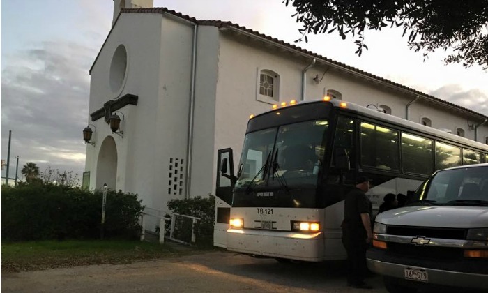Photo: Most days a bus carrying women and children from Texas detention centers arrives at San Antonio Mennonite Church, where volunteers from Casa RAICES greet them. Photo provided. 