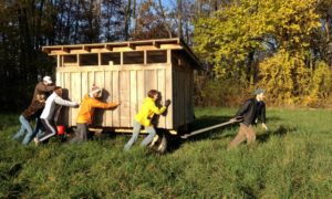 Zirkle and other students move the 'egg mobile' at the Sustainability Summit in November 2013. 