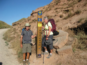 Don and Deb Schmidt pose in front of a Camino trail marker on a day’s hike occurring in the first third of their pilgrimage in northern Spain. Photo provided.