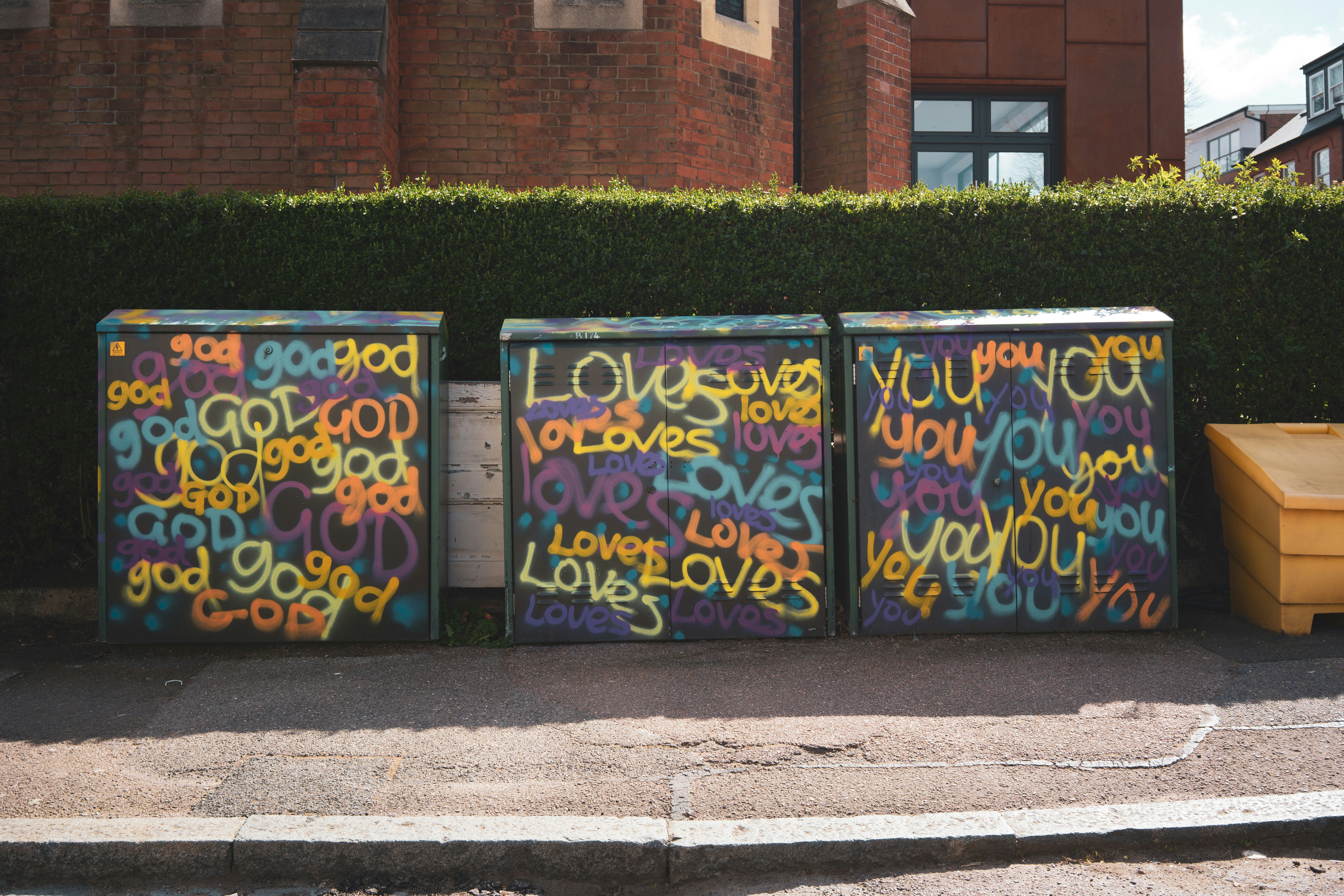 Spray painted God Loves You, over and over again in different colors.